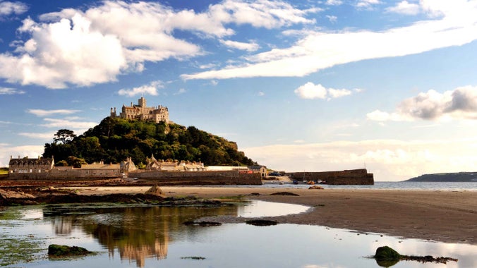 A view across the water at low tide at St Michael's Mount in the distance